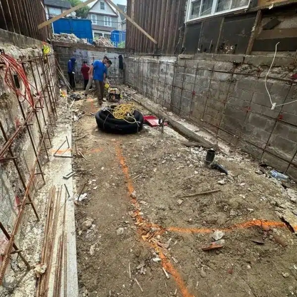 Main sewer & Main water line 12 a group of people standing in a dirt area