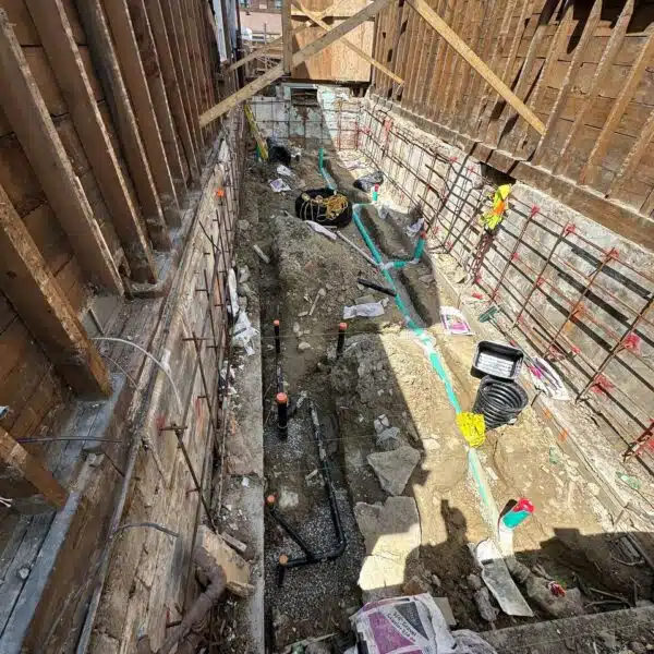 Main sewer & Main water line 15 a construction site with a hole in the ground