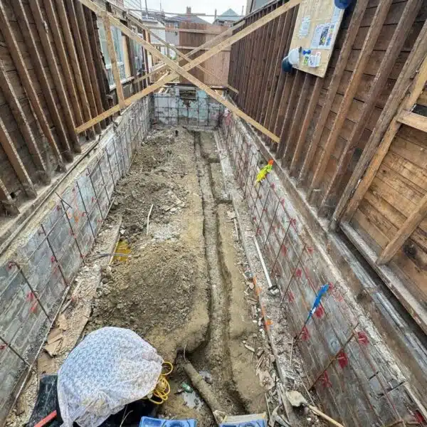 Main sewer & Main water line 10 a construction site with a hole in the ground
