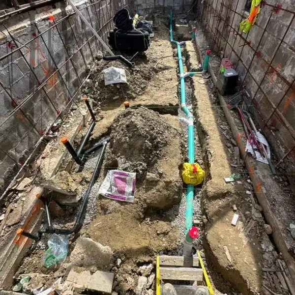 Main sewer & Main water line 11 a construction site with dirt and pipes