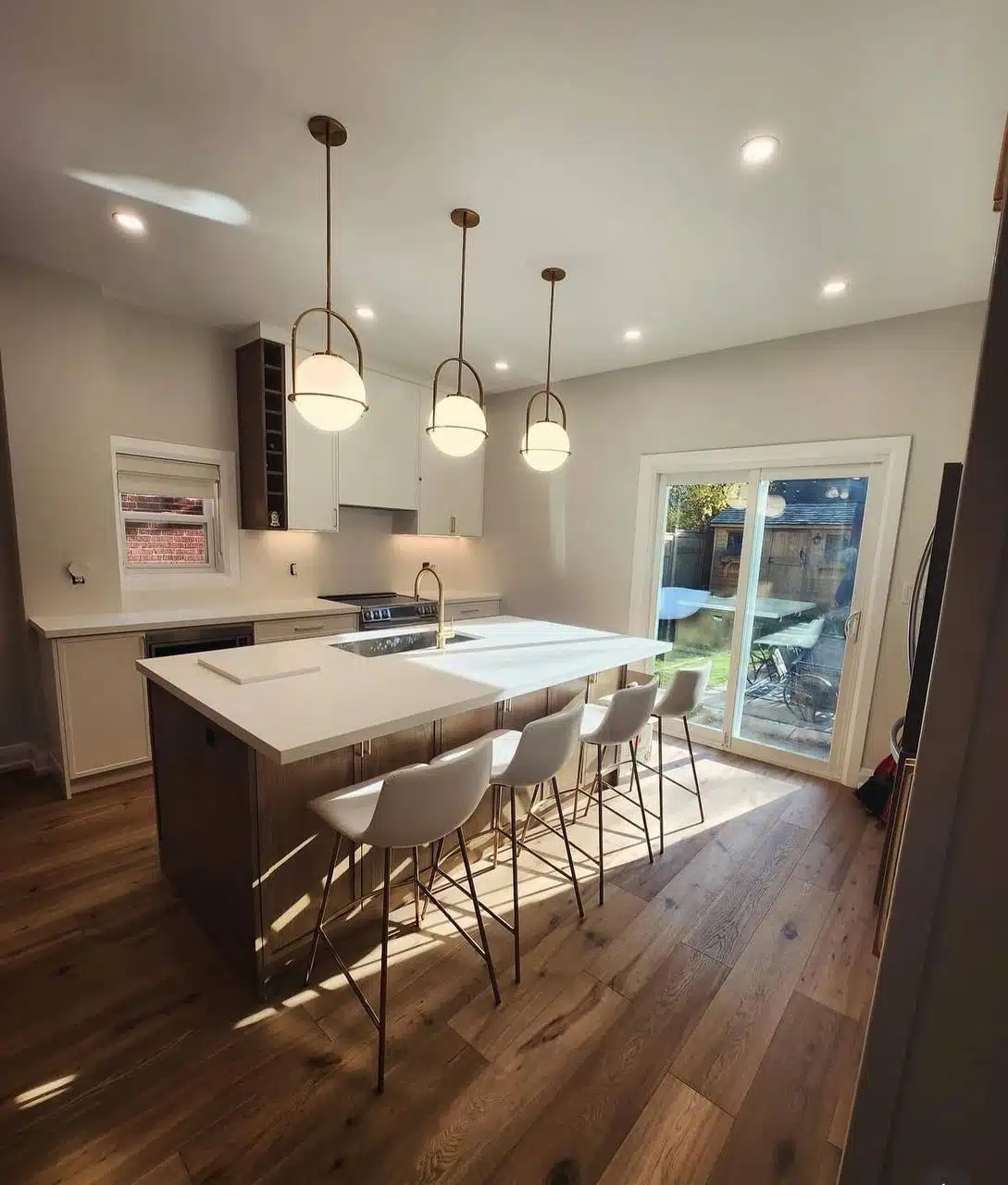 a kitchen with a bar and stools aquaman plumbing finishing project