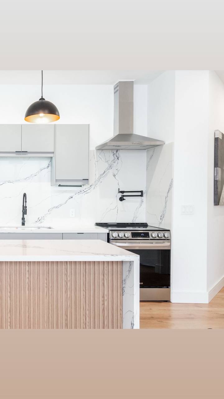 a kitchen with a bar and stools aquaman plumbing finishing project